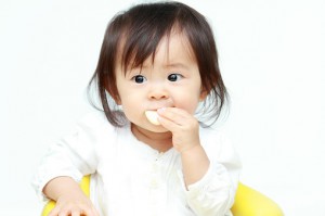 asian baby eating 497032104