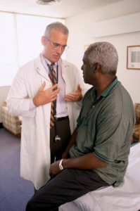 Male doctor talking to a male patient