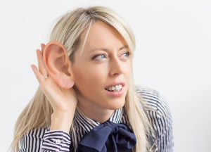 Woman listening with big ear