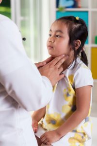 Pediatrician examining lymph nodes