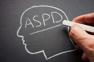 Hand written abbreviation ASPD antisocial personality disorder in chalk.