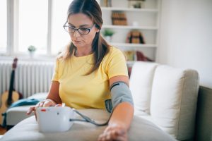 Photo of woman checking blood presure at home