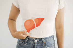 Woman holding liver, hepatitis vaccination, liver cancer treatment