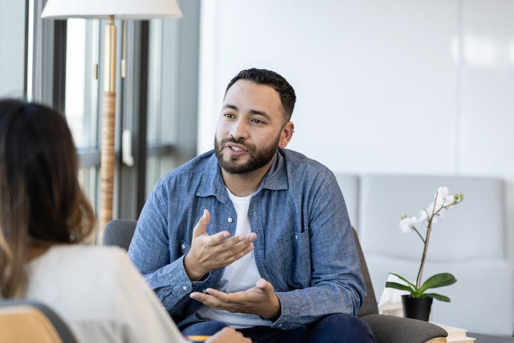 Female doctor talking with patient during psychiatric consultation