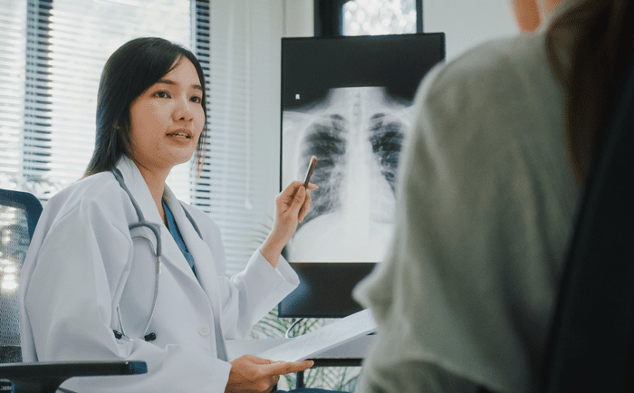 Doctor showing a patient an X‑ray during an outpatient visit